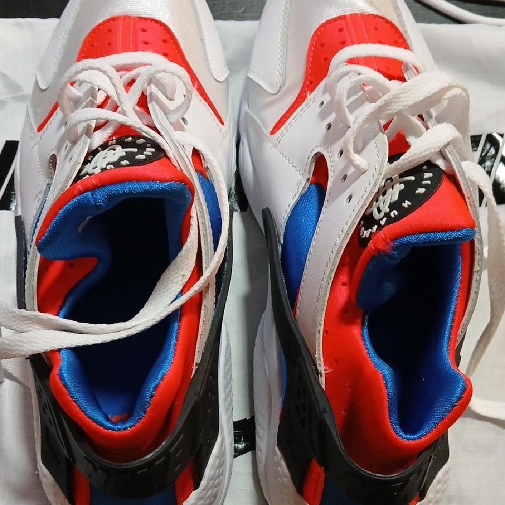 Nike Air Huarache sneaker in a white, red, and blue colorway. 